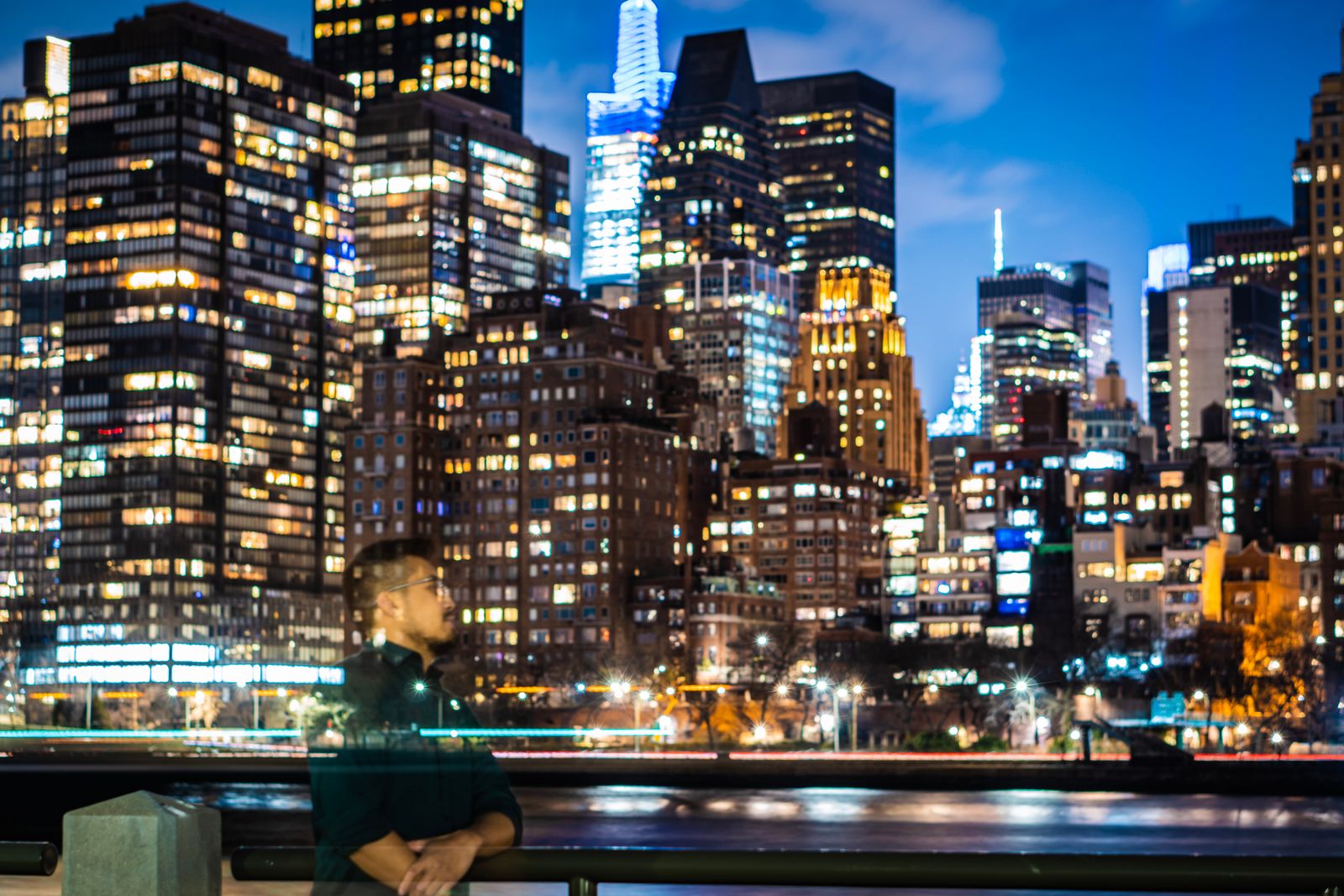 Portrait at night against a city skyline